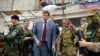 Ukraine -- Ukrainian MP and withdrew candidate in the 2014 Ukrainian presidential election, Oleh Tsaryov (2L), stands next to Vostok Battalion guards outside the self-proclaimed "Donetsk People's Republic" headquarters in Donetsk, June 12, 2014